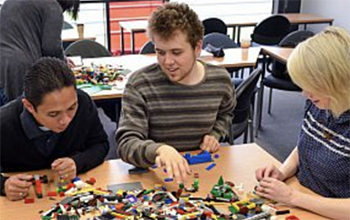 Three people building with lego at the Ƶ